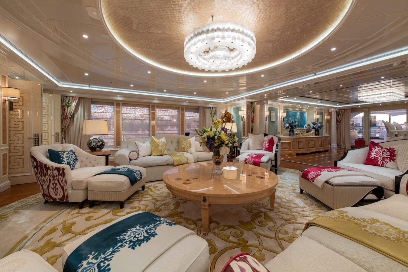 a large living room with a large chandelier aboard EYE Yacht for Sale