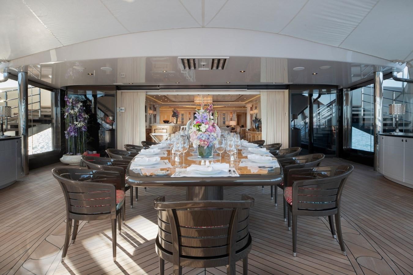 a large room with a table and chairs aboard EYE Yacht for Sale