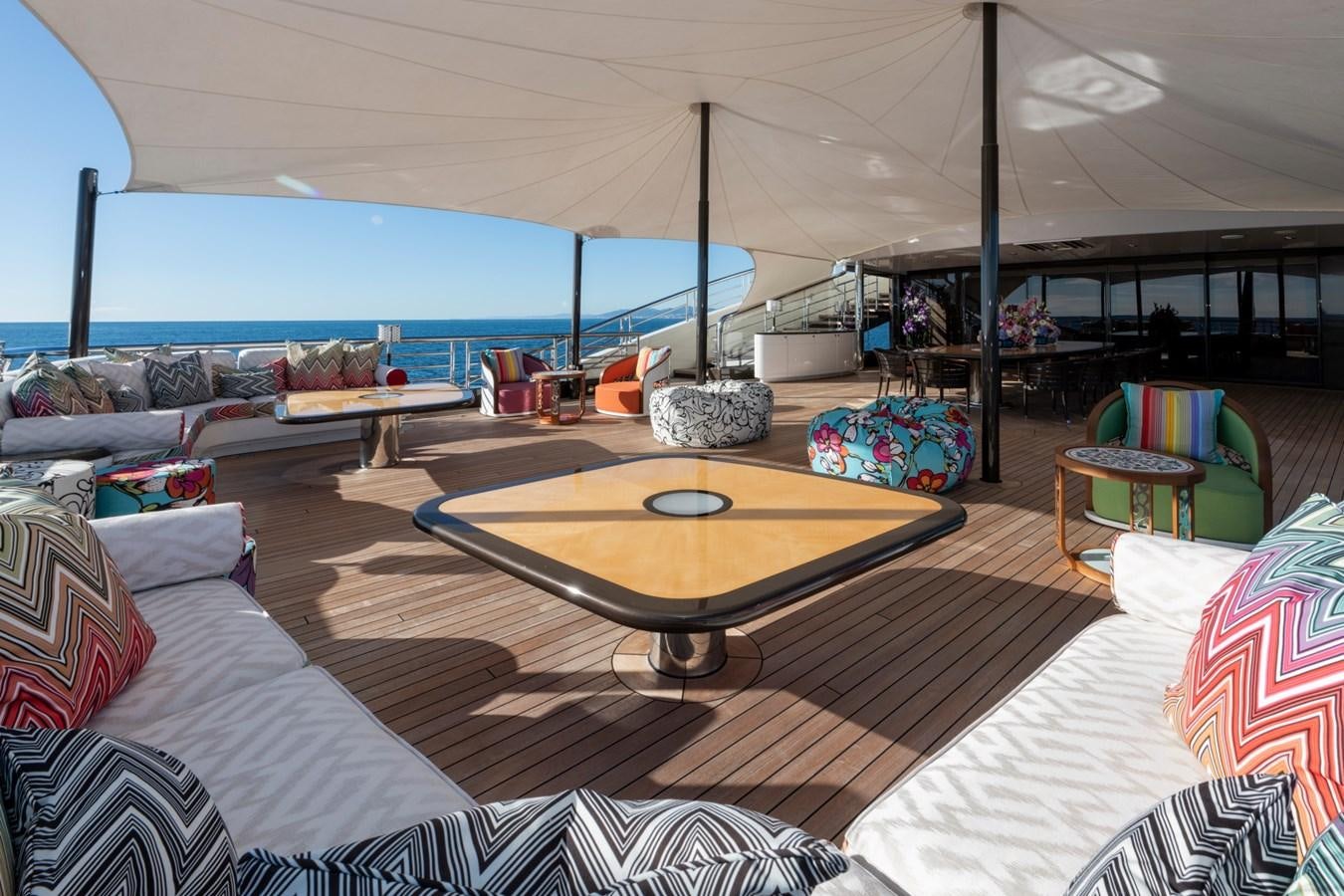 a large room with a table and chairs aboard EYE Yacht for Sale