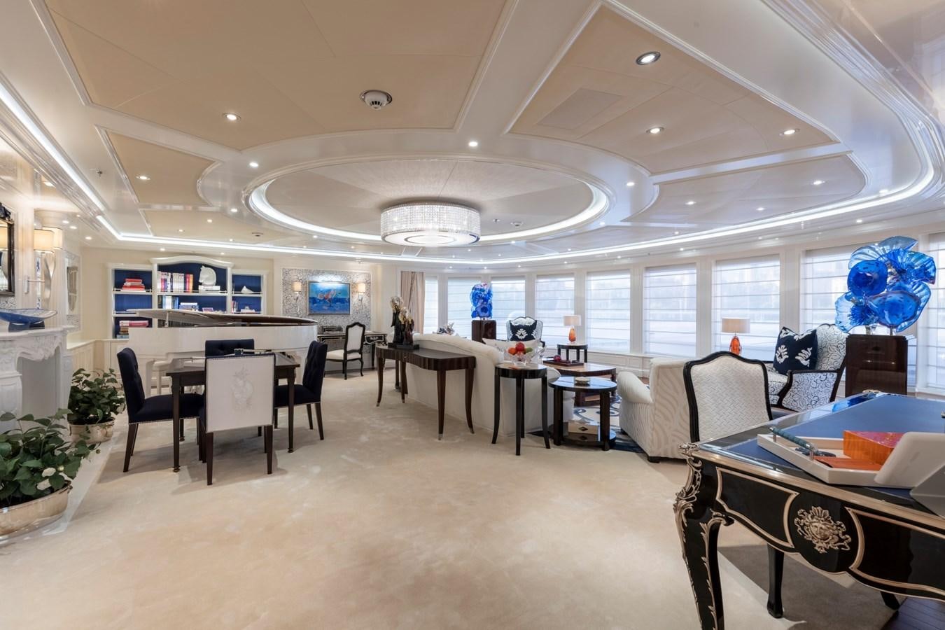 a room with tables and chairs aboard EYE Yacht for Sale