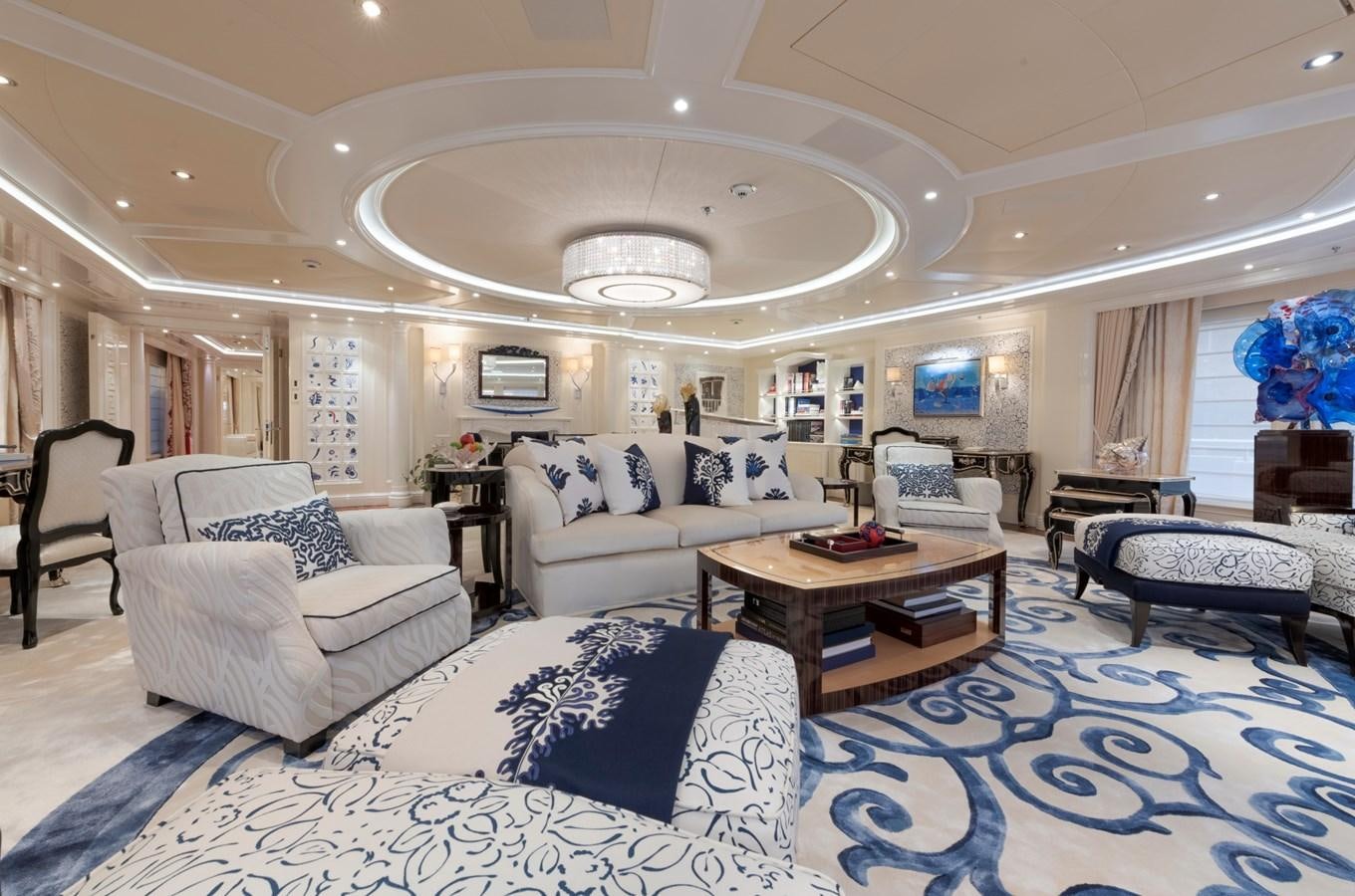 a large living room with a large blue and white rug aboard EYE Yacht for Sale