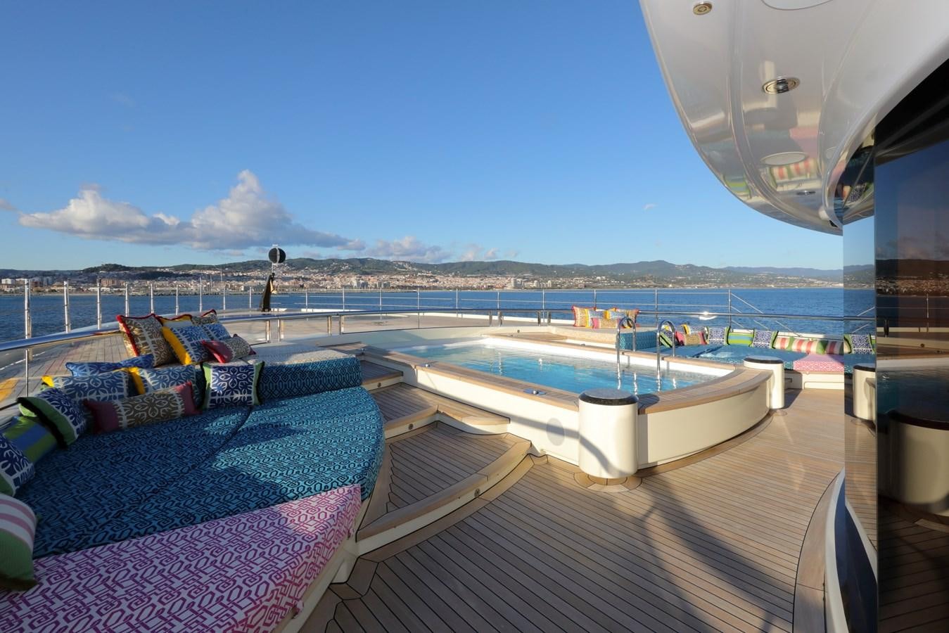 a deck with a pool and a view of the water aboard EYE Yacht for Sale