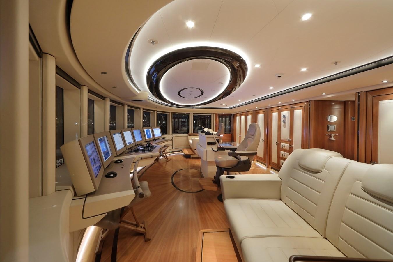 a room with a large mirror and a couch and chairs aboard EYE Yacht for Sale