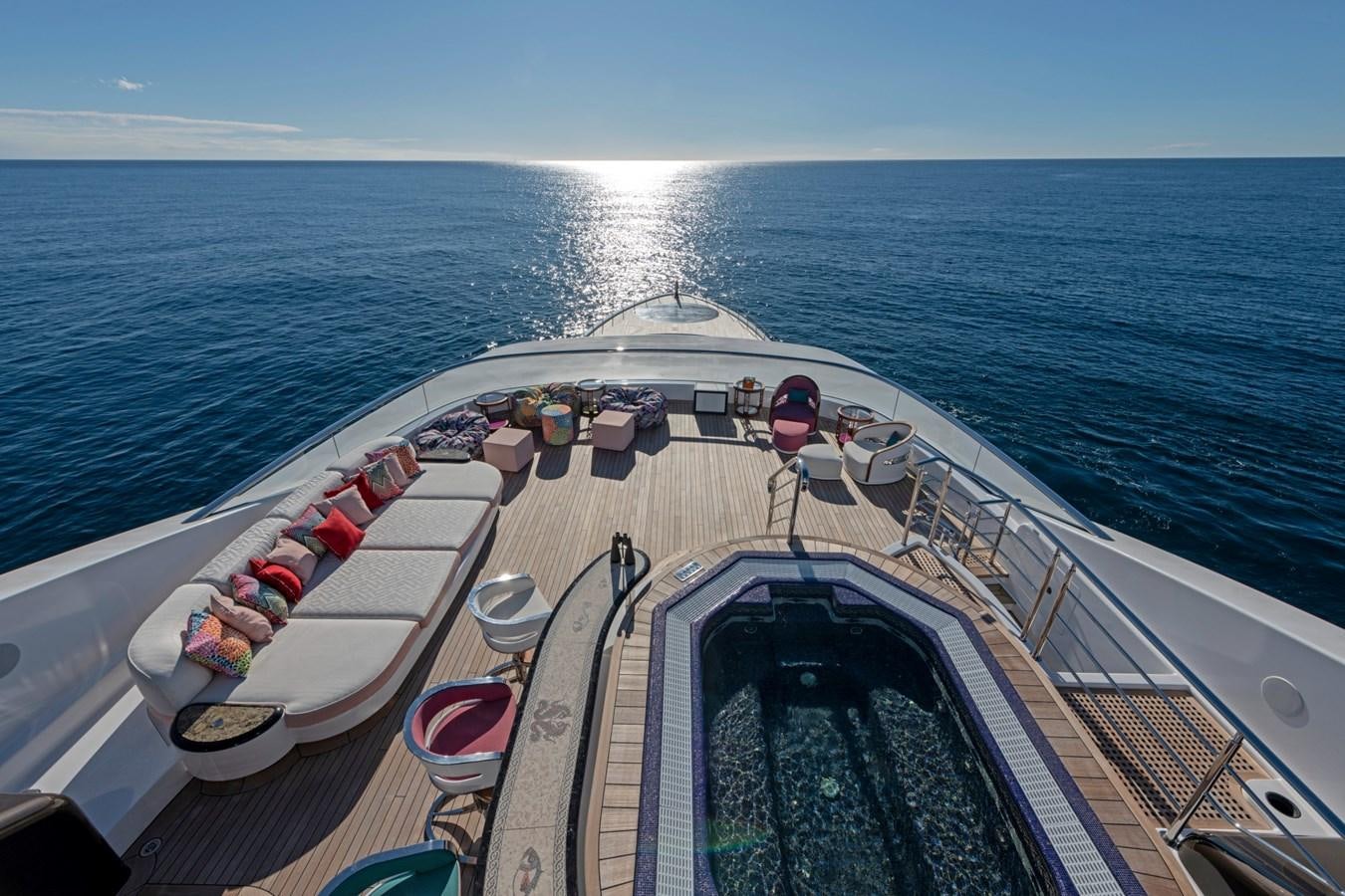 a large ship with a deck and a large body of water in the background aboard EYE Yacht for Sale