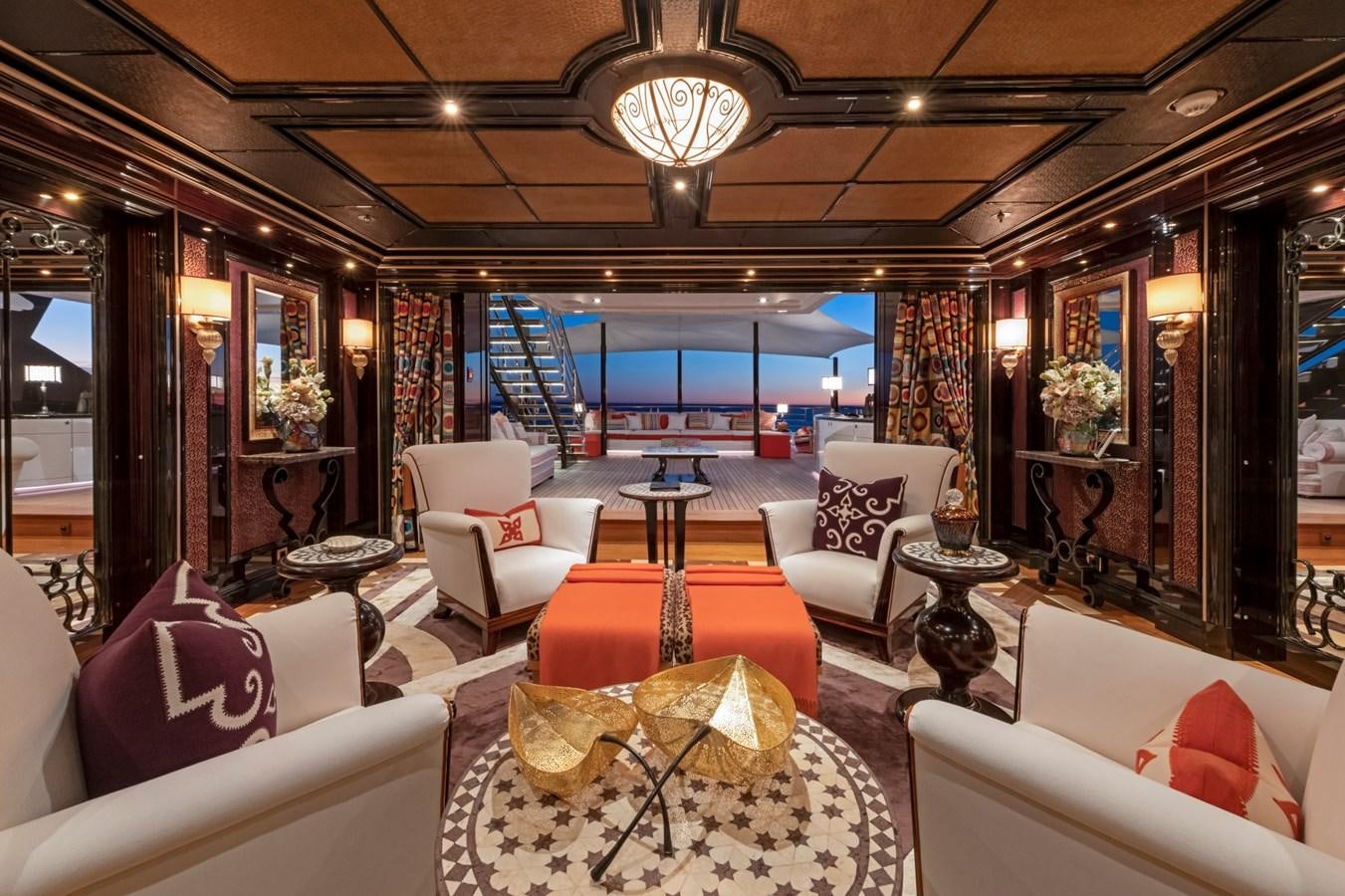 a room with a large window and a table with chairs and a large window with a view of aboard EYE Yacht for Sale