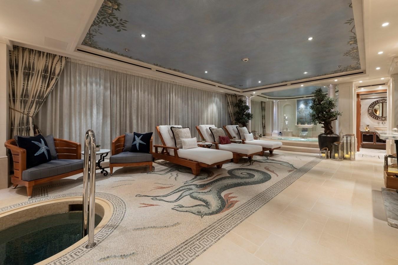 a large living room with a large rug aboard EYE Yacht for Sale