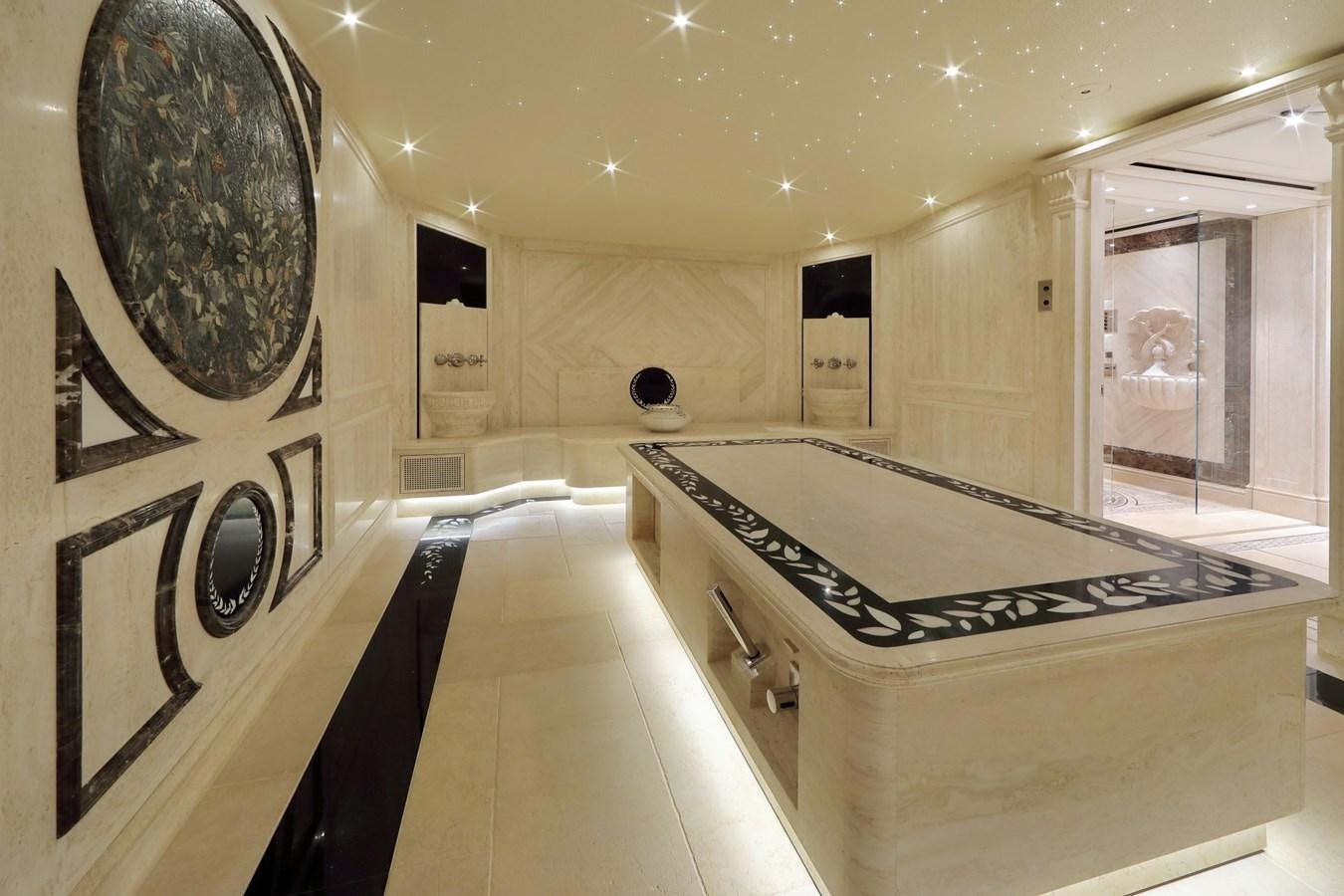 a large room with a large black and white table and chairs aboard EYE Yacht for Sale
