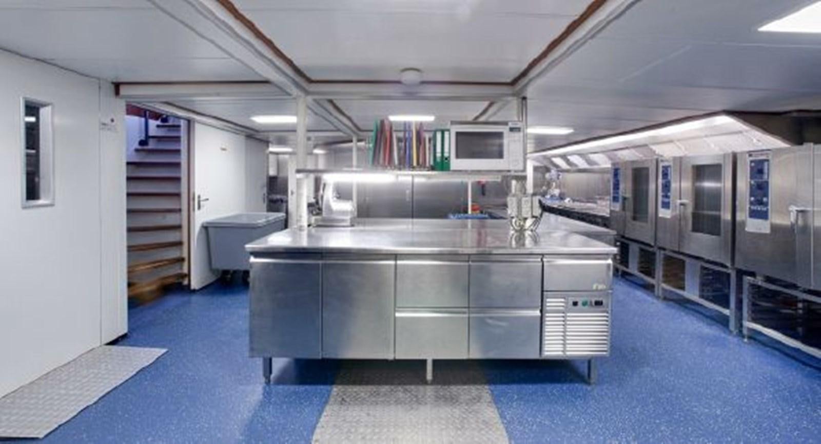 a large kitchen with a large island aboard MAJESTEIT Yacht for Sale