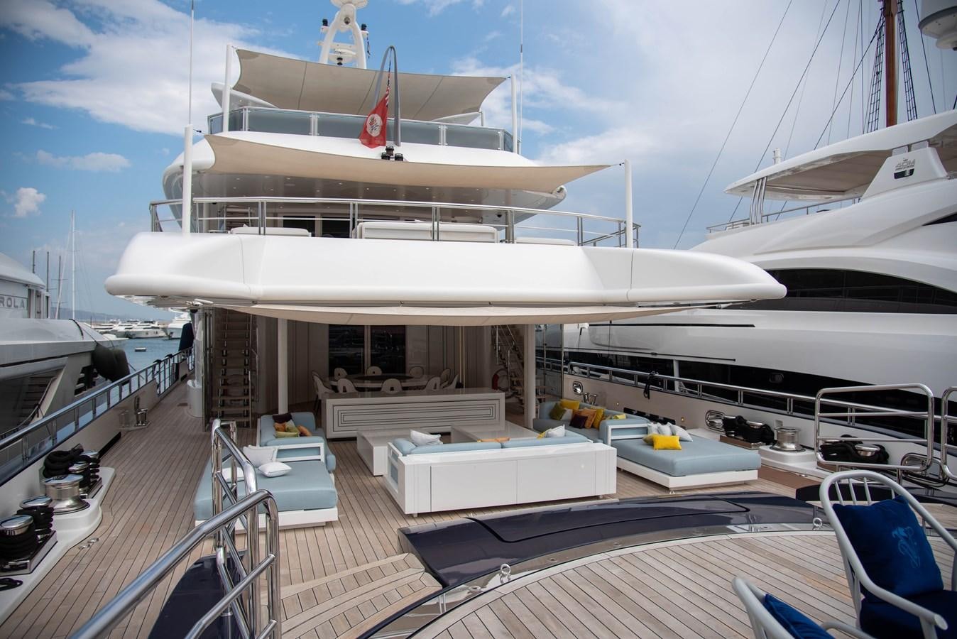 a large white ship docked aboard LADY VERA Yacht for Charter