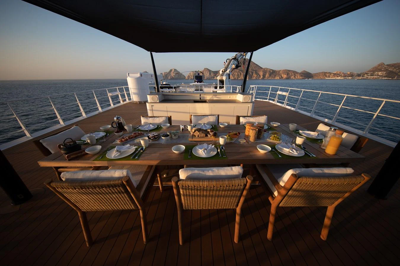 a table with plates and food on it aboard INDRATUS Yacht for Sale