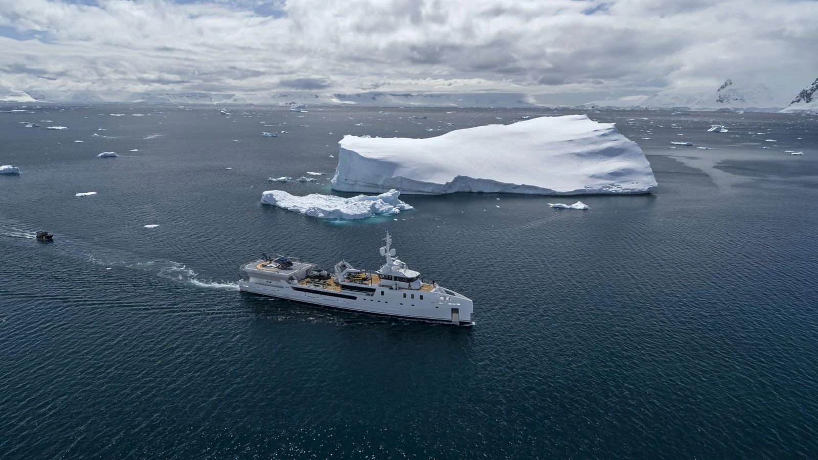 a ship in the water with icebergs in the background aboard INDRATUS Yacht for Sale