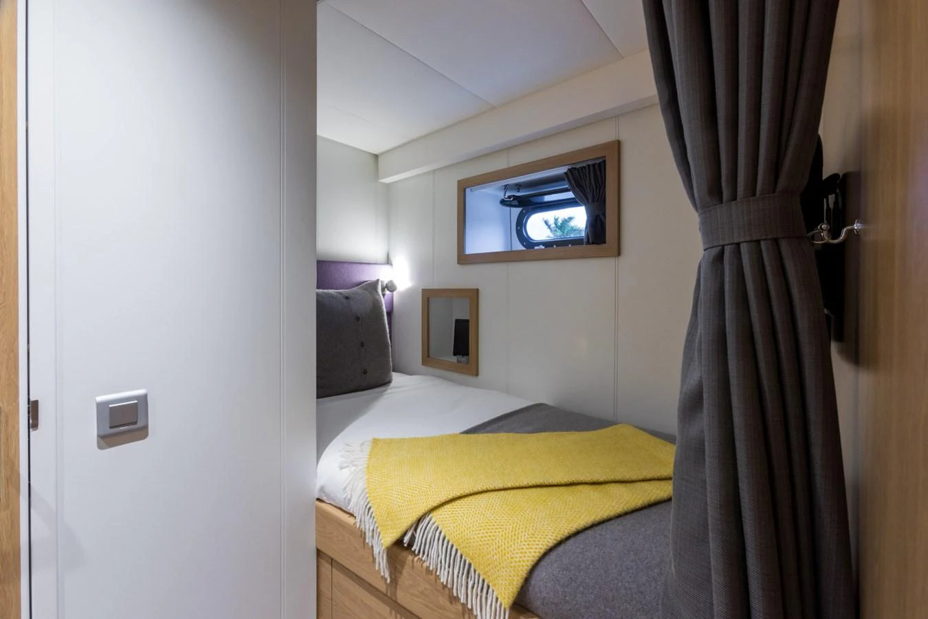 a bedroom with a tv on the wall aboard INDRATUS Yacht for Sale