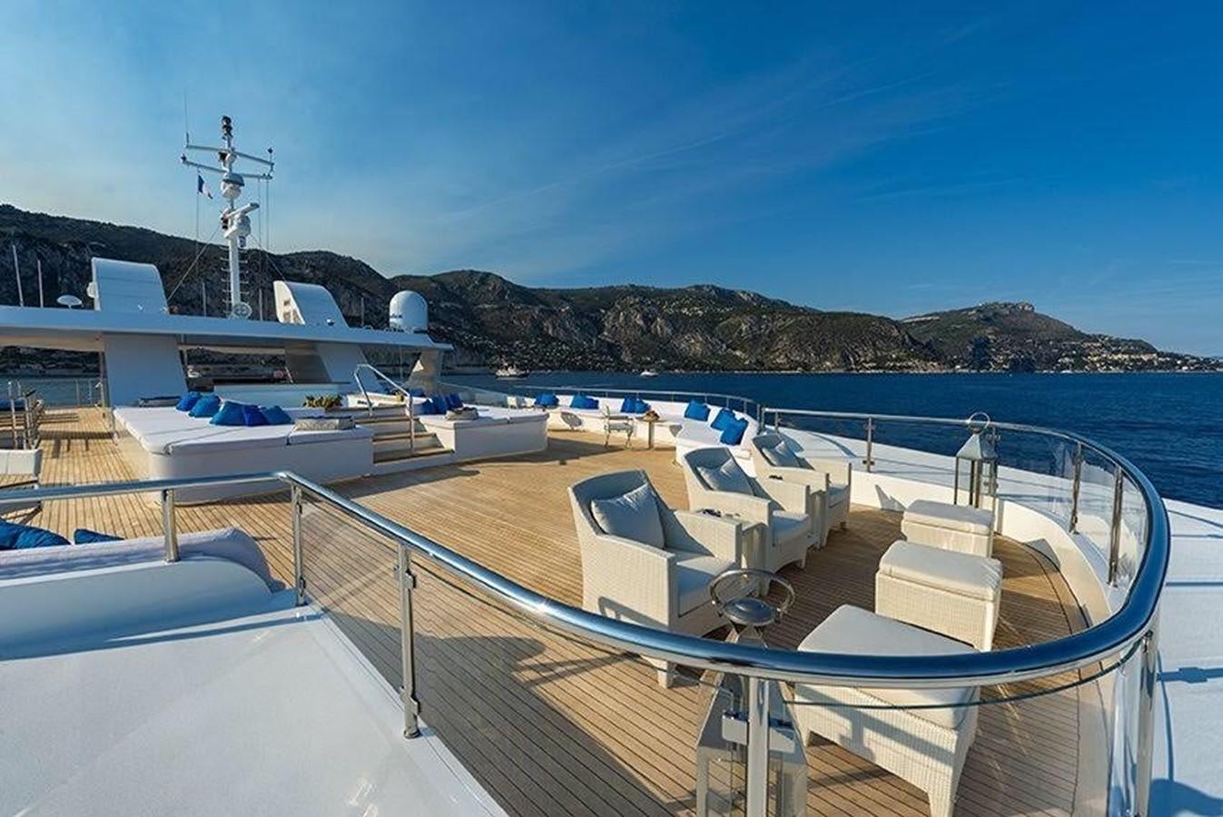 a deck of a boat on a body of water with mountains in the background aboard MARQUISE Yacht for Sale