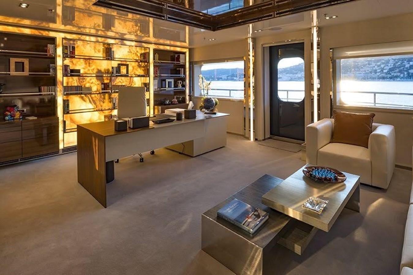 a living room with a large book shelf and a desk aboard MARQUISE Yacht for Sale