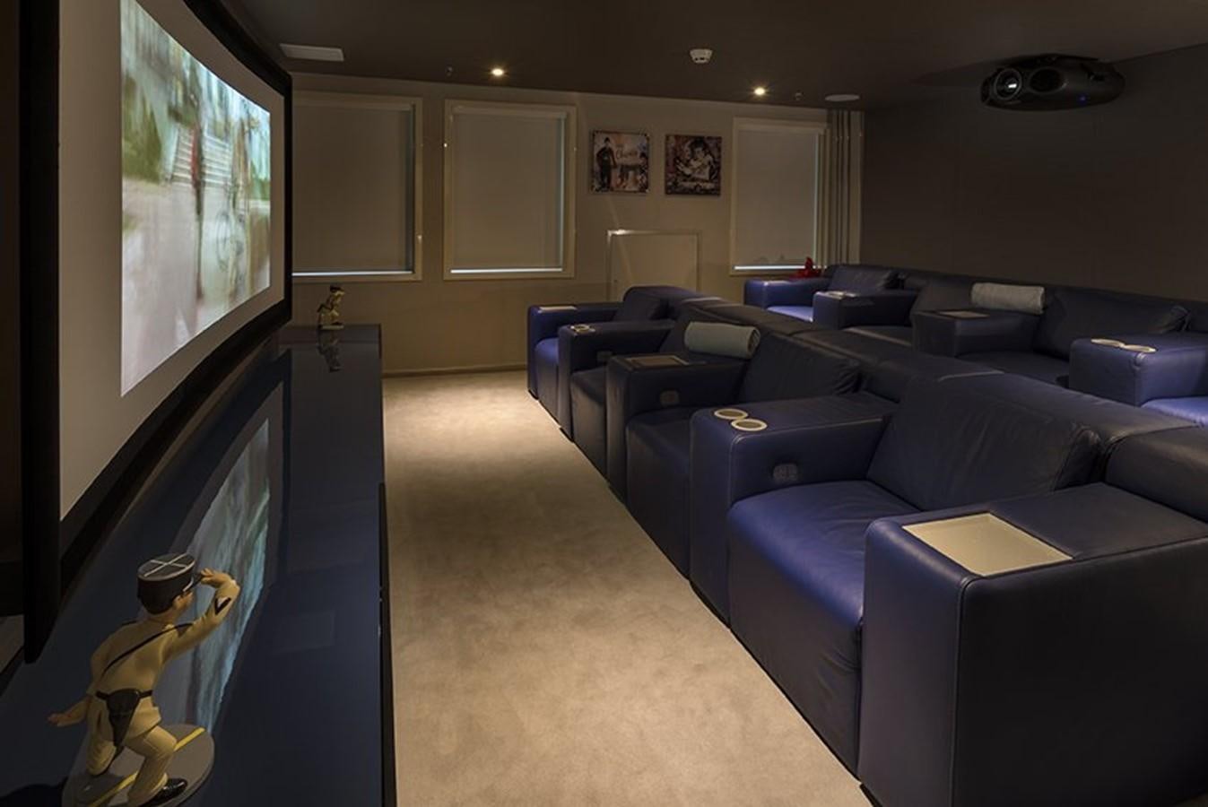 a living room with blue couches and a television aboard MARQUISE Yacht for Sale