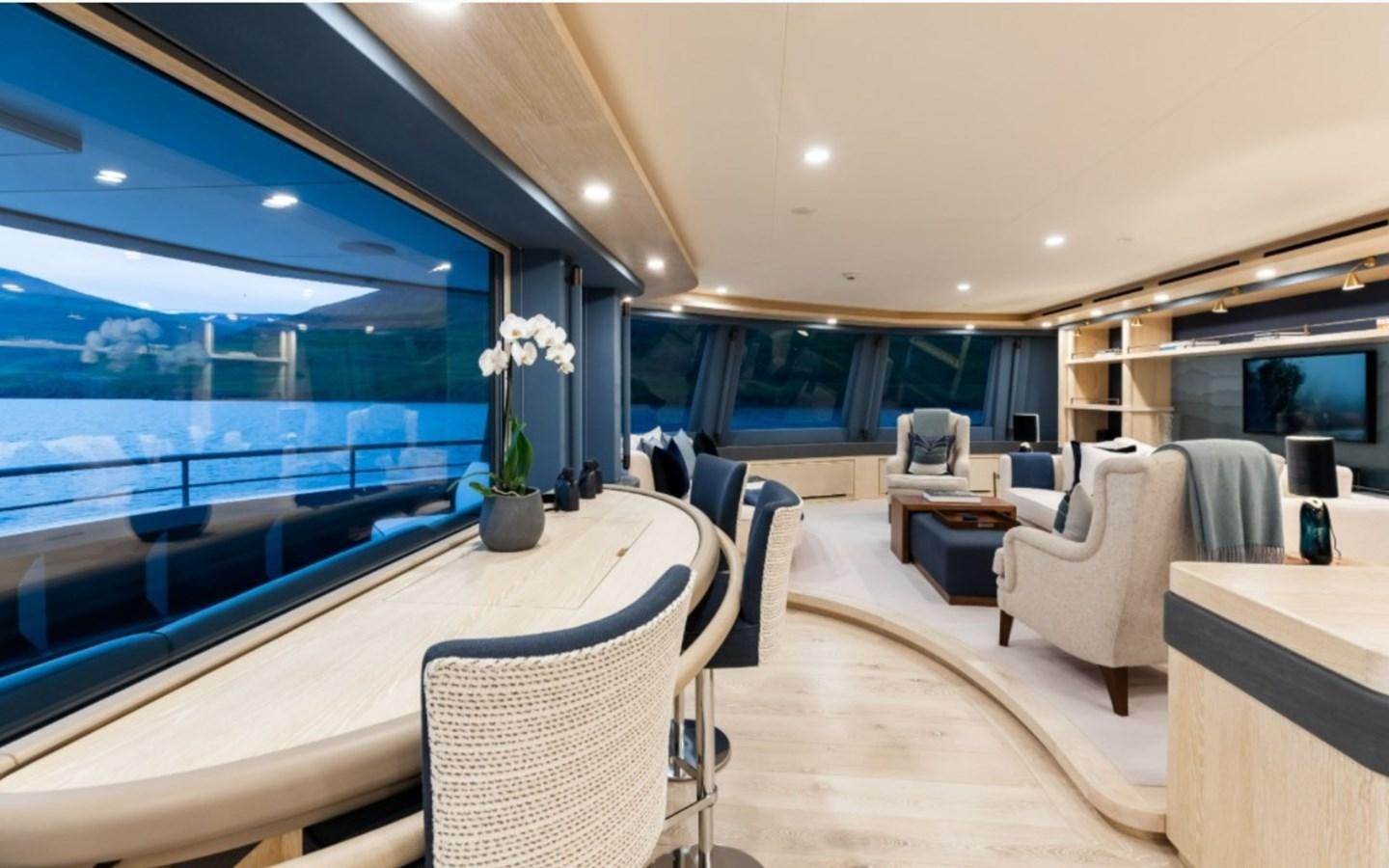 a large modern looking room with a large swimming pool aboard Q Yacht for Sale