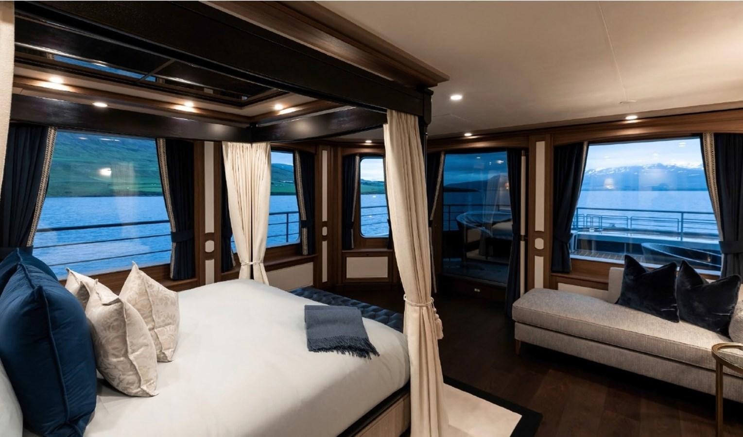 a room with a bed and a couch aboard Q Yacht for Sale