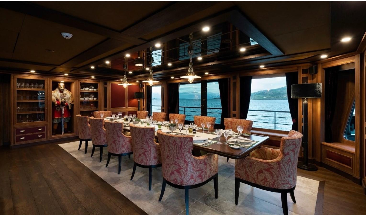 a dining room with a table and chairs aboard Q Yacht for Sale