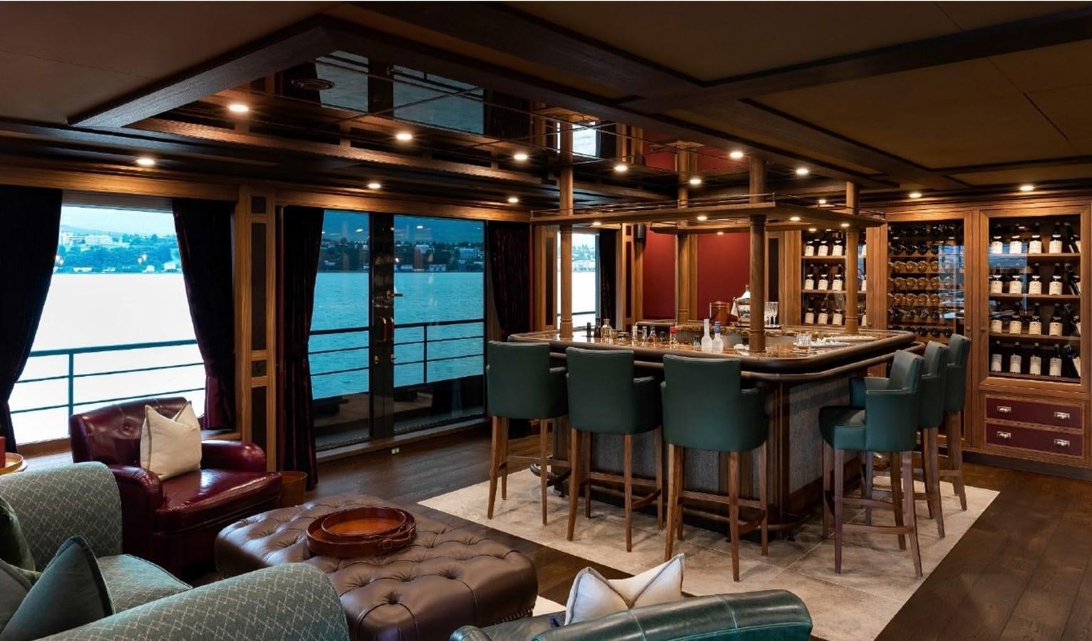 a room with a table chairs and a large window aboard Q Yacht for Sale