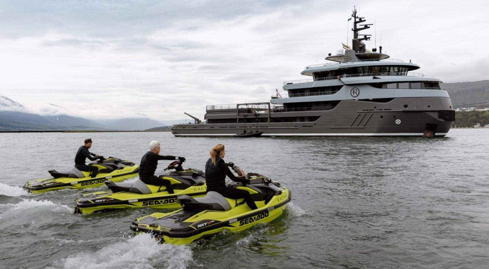 a group of people in a boat with a boat in the background aboard Q Yacht for Sale