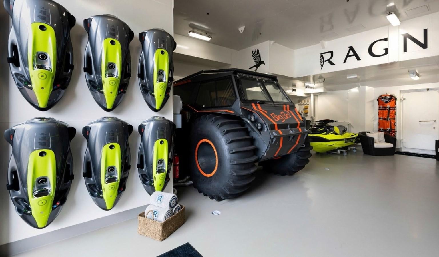 a group of cars in a garage aboard Q Yacht for Sale
