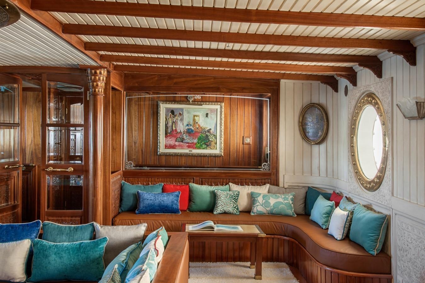 a living room with a couch and a mirror aboard NORTH SEA Yacht for Sale
