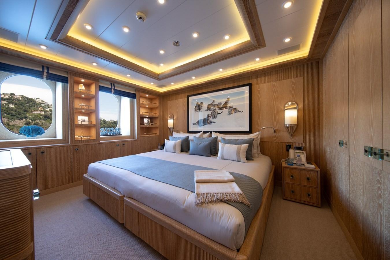a bedroom with a bed and a window aboard AHS Yacht for Sale