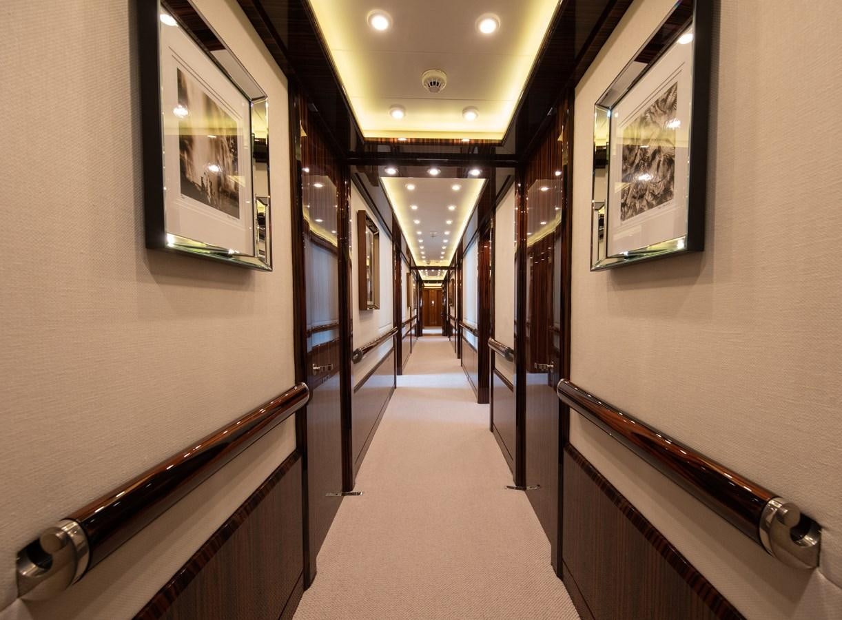 a hallway with framed pictures aboard AHS Yacht for Sale
