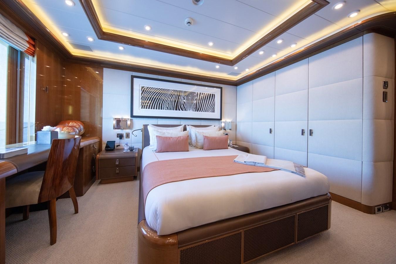 a bedroom with a bed and a chair aboard AHS Yacht for Sale