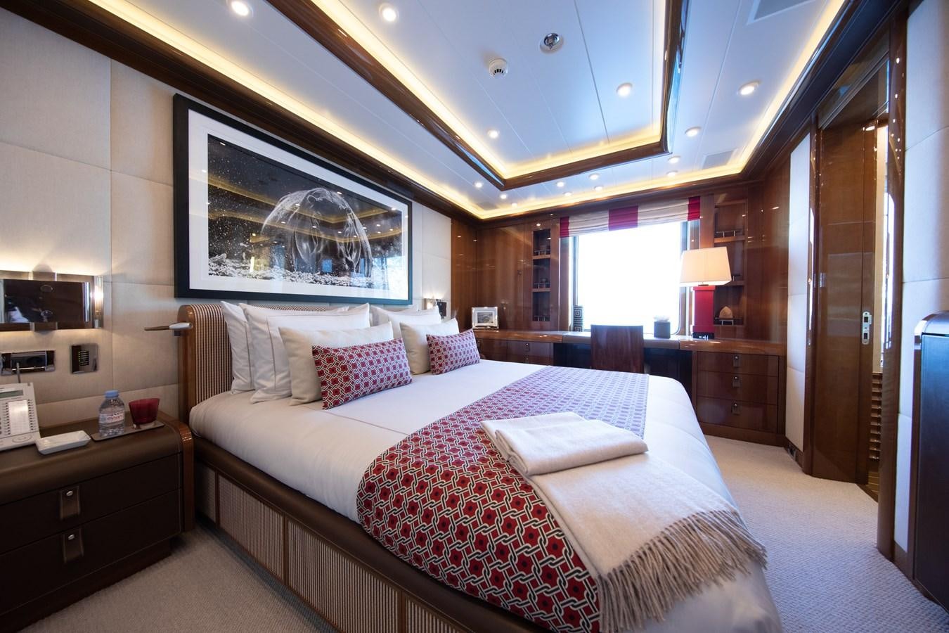 a bedroom with a bed and a desk aboard AHS Yacht for Sale