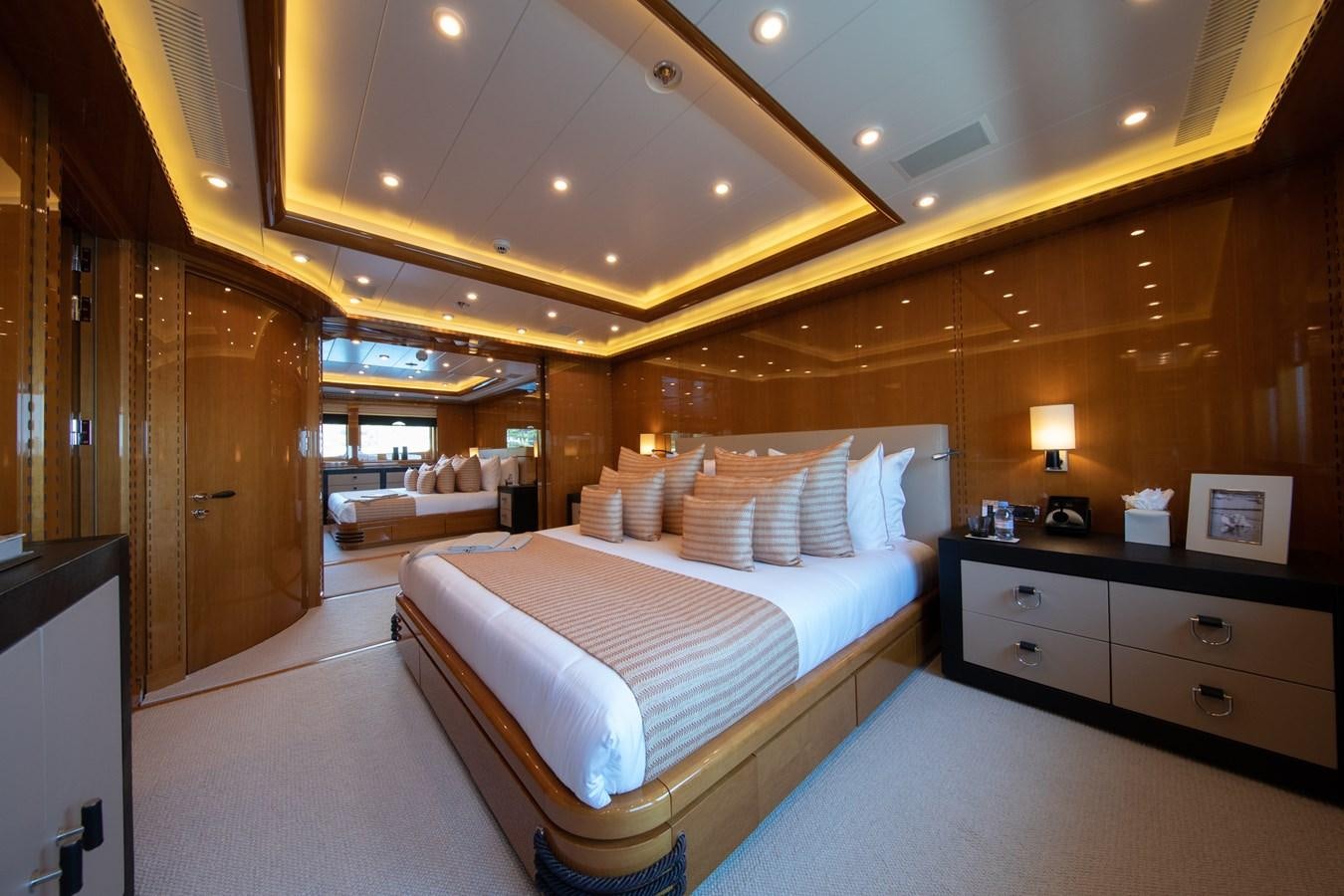 a room with a bed and a desk aboard AHS Yacht for Sale