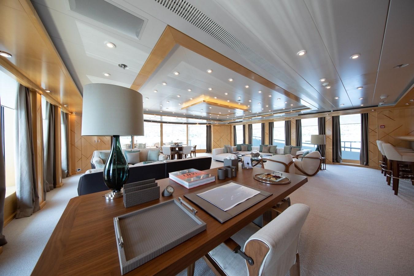 a large room with a table and chairs aboard AHS Yacht for Sale