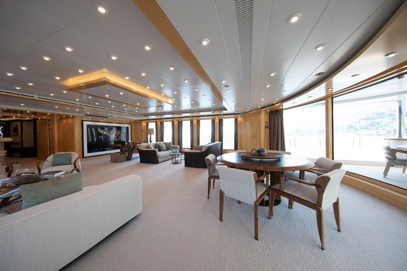 a living room with a table and couches aboard AHS Yacht for Sale