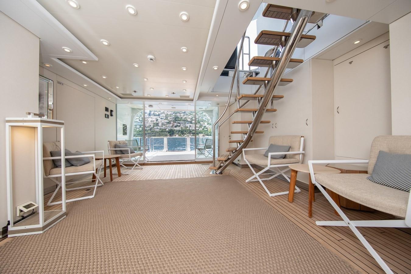 a room with a couch and a staircase aboard AHS Yacht for Sale