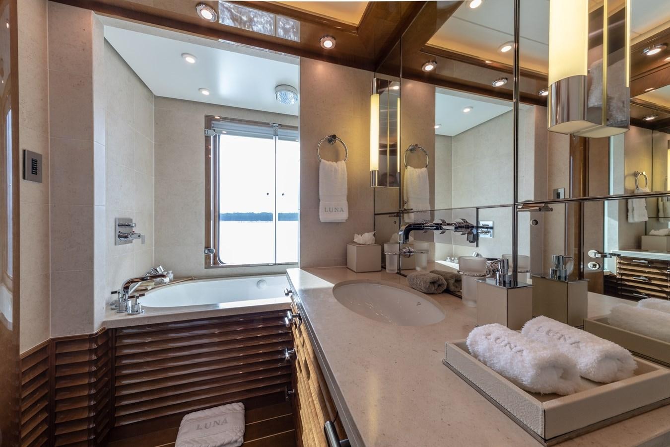 a bathroom with a large mirror aboard AHS Yacht for Sale