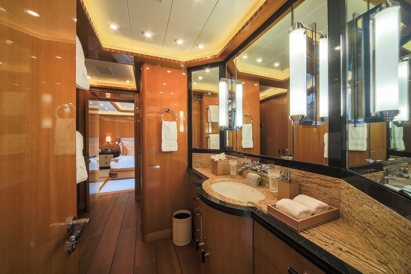 a bathroom with a countertop sink and mirror aboard AHS Yacht for Sale
