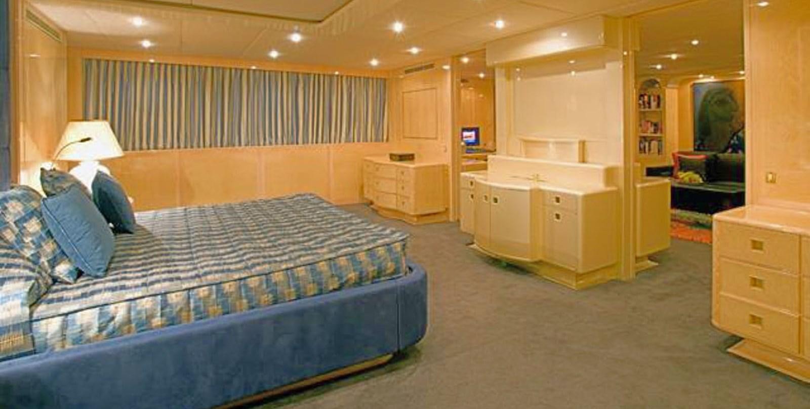 a bedroom with a bed and a desk aboard ADAMAS V Yacht for Sale