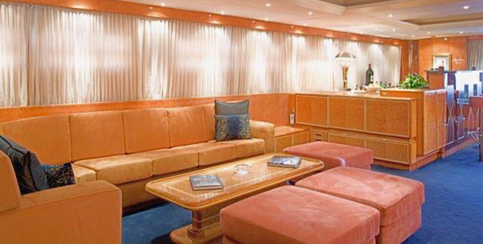 a living room with a couch and a coffee table aboard ADAMAS V Yacht for Sale