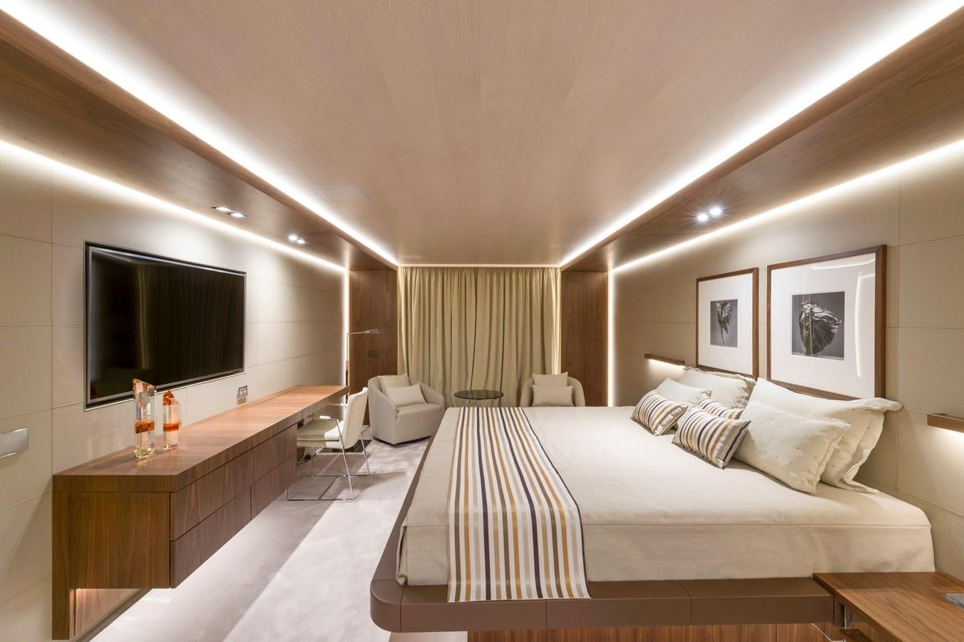a room with a bed and a tv aboard UTOPIA IV Yacht for Sale