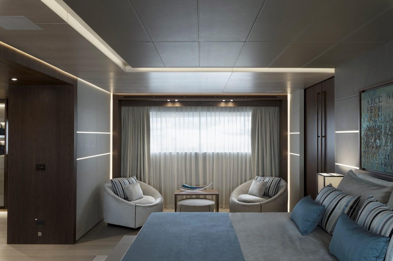 a room with a bed and a chair aboard UTOPIA IV Yacht for Sale