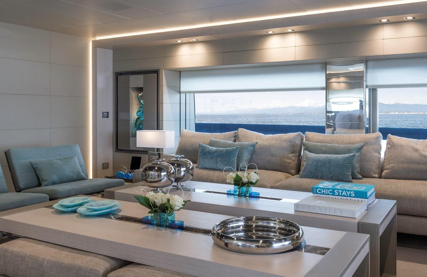 a living room with a large window aboard UTOPIA IV Yacht for Sale