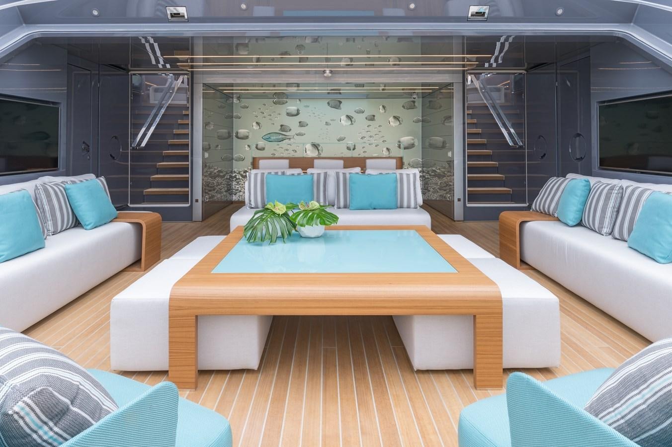 a living room with a table and couches aboard UTOPIA IV Yacht for Sale