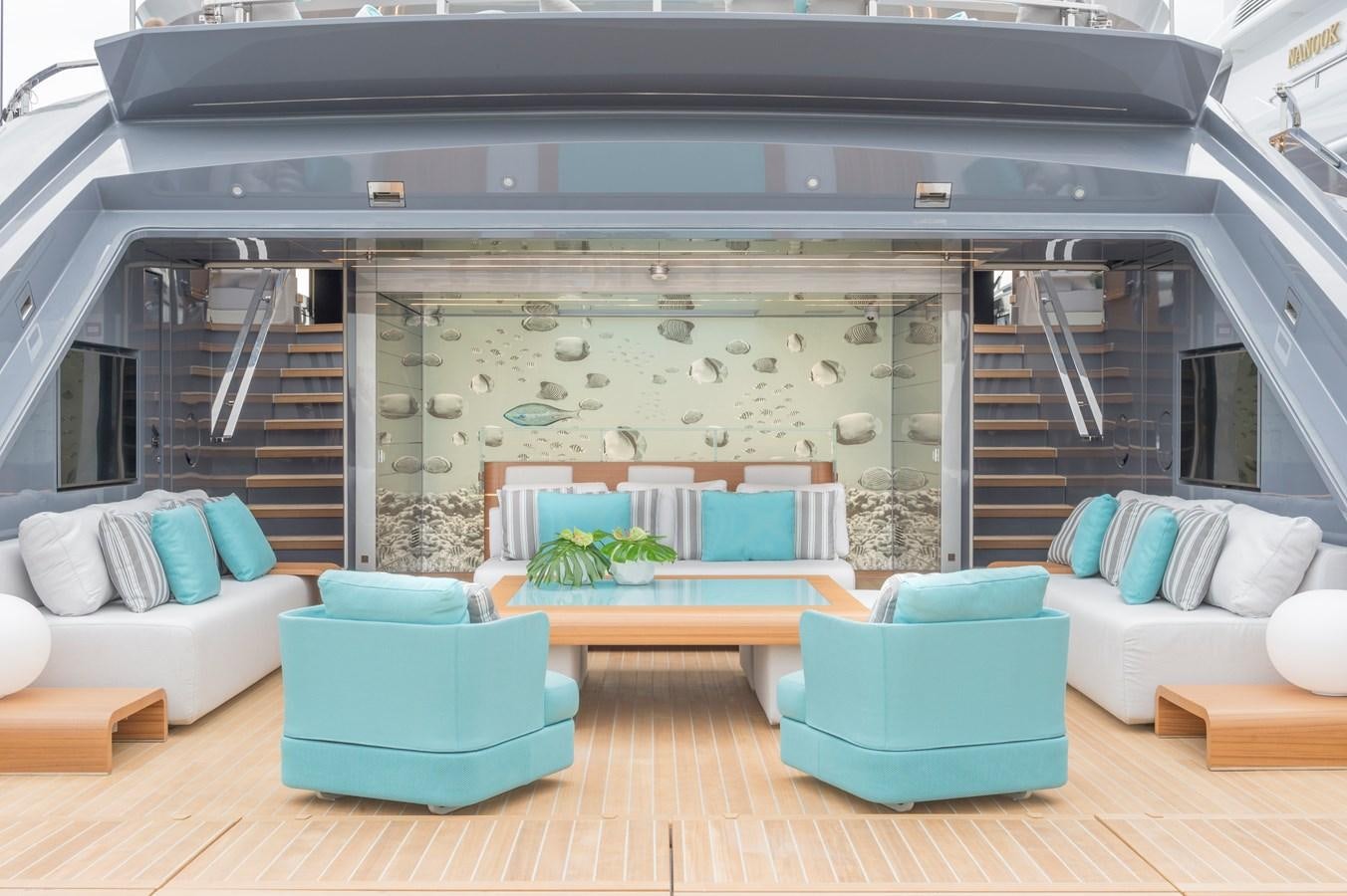 a living room with a large open staircase aboard UTOPIA IV Yacht for Sale