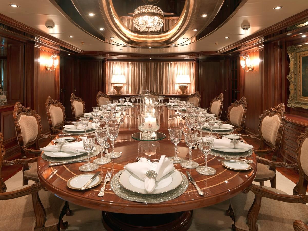a large dining room with a chandelier aboard APOGEE Yacht for Sale