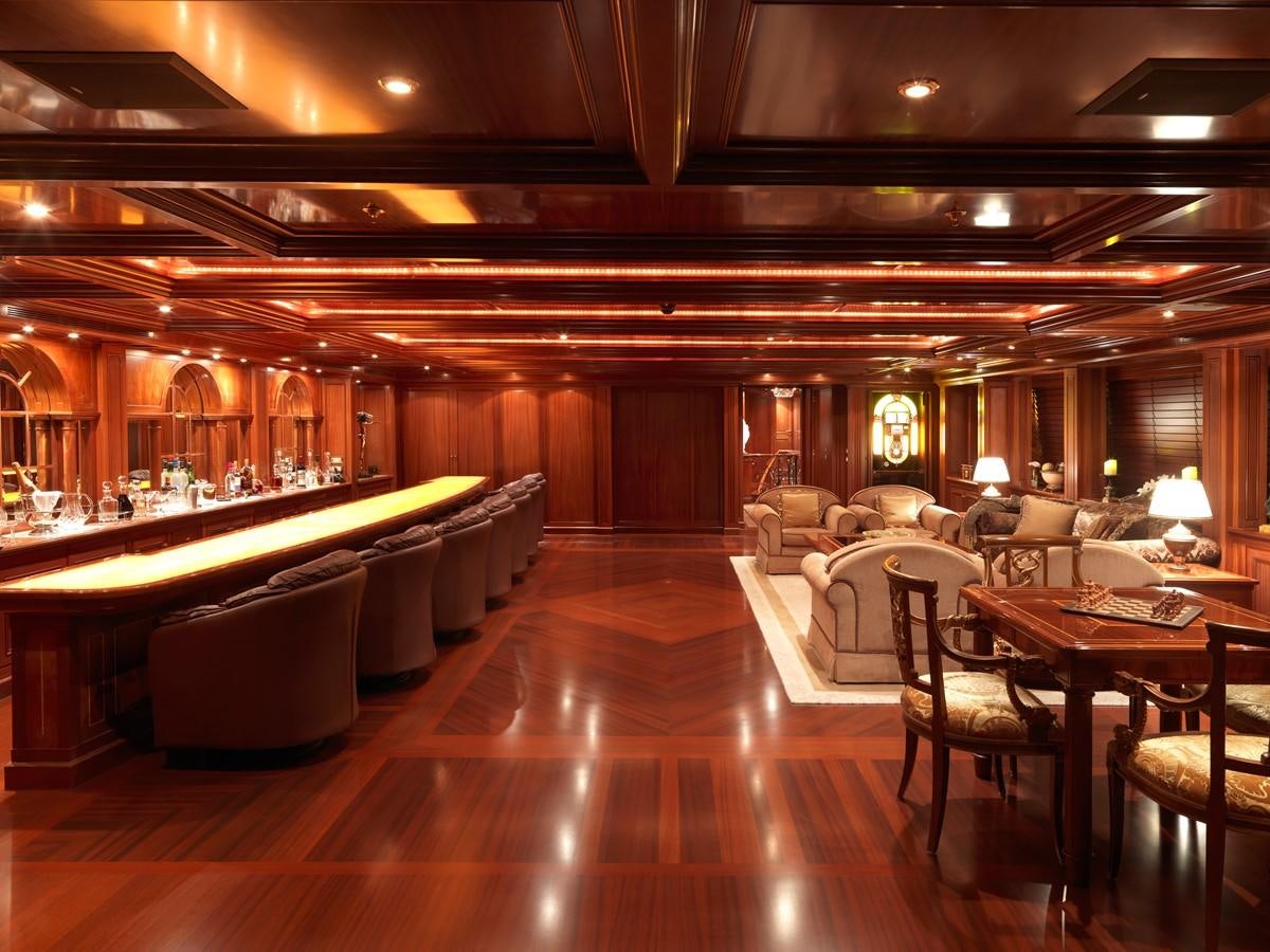 a large room with a table and chairs aboard APOGEE Yacht for Sale