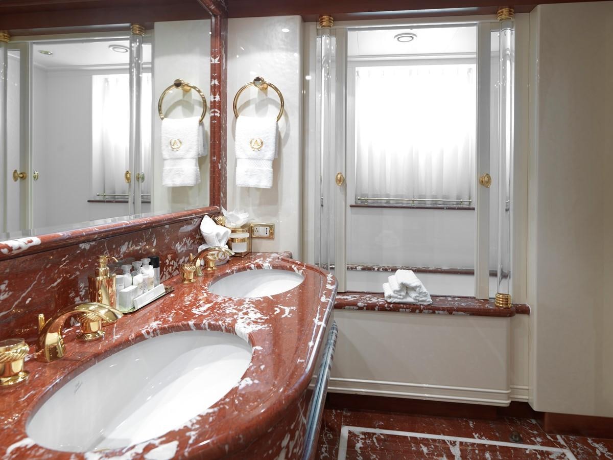a bathroom with a tub sink and a mirror aboard APOGEE Yacht for Sale