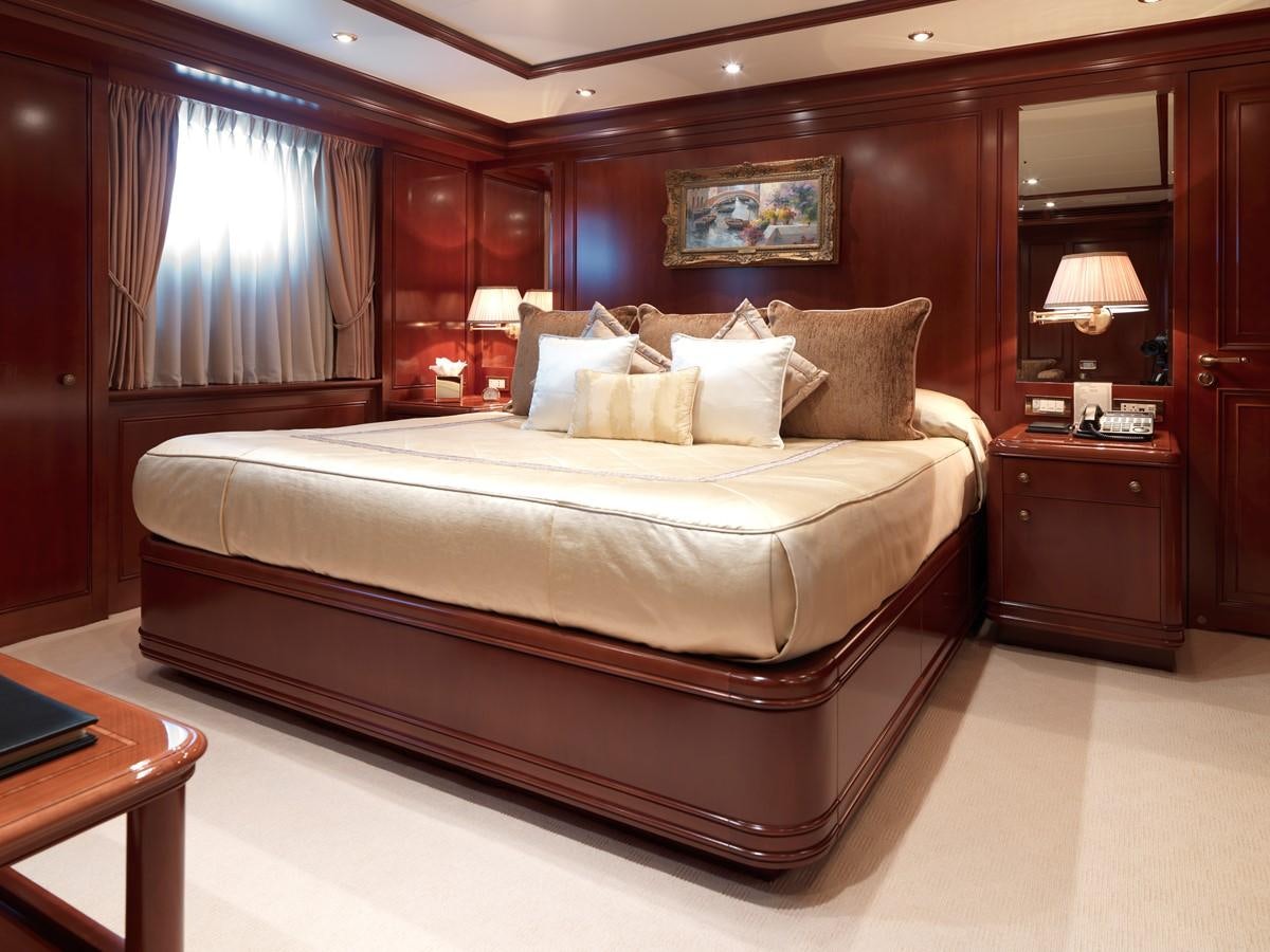 a bed in a room aboard APOGEE Yacht for Sale