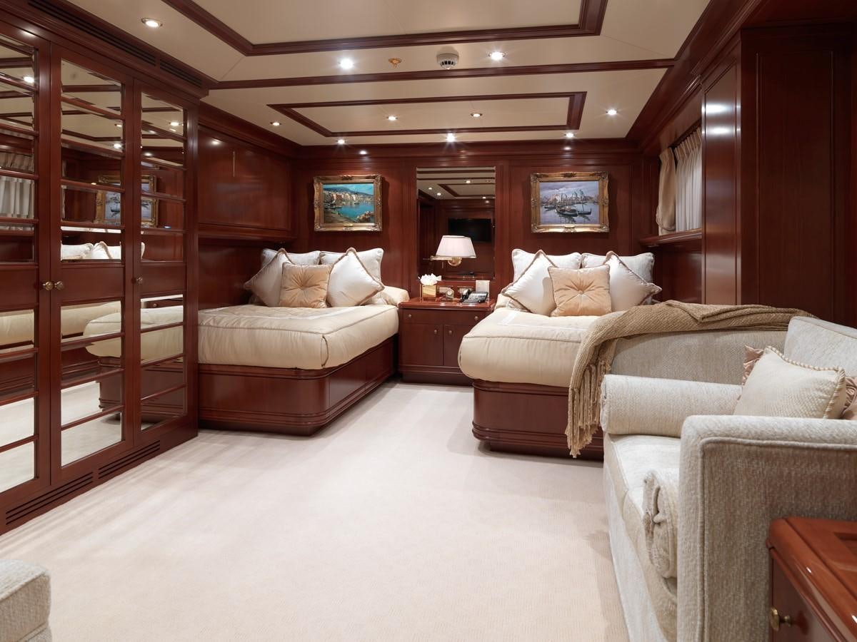 a room with a bed and a mirror aboard APOGEE Yacht for Sale