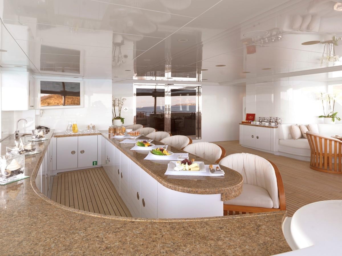 a modern looking kitchen with white furniture aboard APOGEE Yacht for Sale