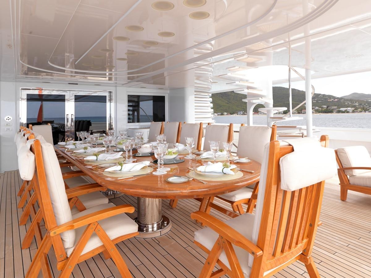 a table set for a dinner aboard APOGEE Yacht for Sale